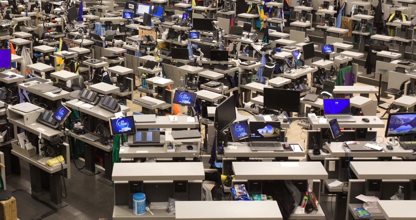An options exchange trading floor in Chicago with rows of empty desks and screens
